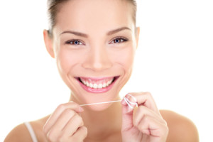 holistic dental patient flossing teeth